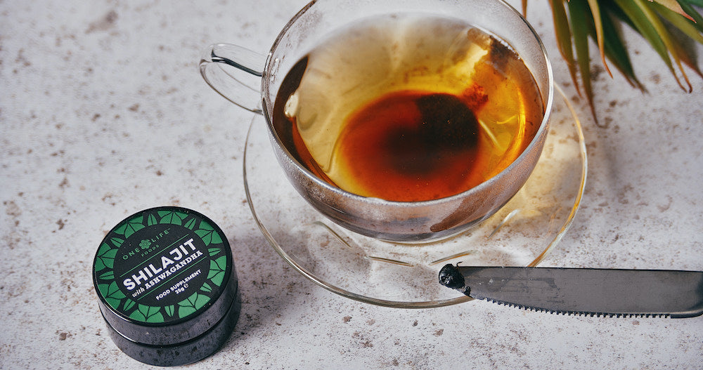 One Life Foods Shilajit & Ashwagandha jar next to a cup of tea on a marble table