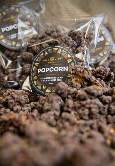 Close up of dark chocolate popcorn with chia seeds and milled hemp